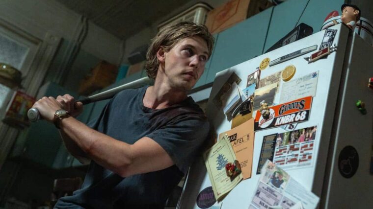 Hank (Austin Butler) cautiously answers his front door in Caught Stealing by Columbia Pictures.